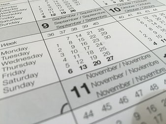 Close-up of white paper calendar showing September and November