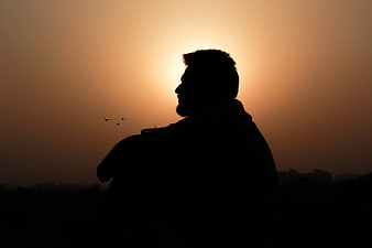 Silhouette of Man Looking at Sunset Horizon