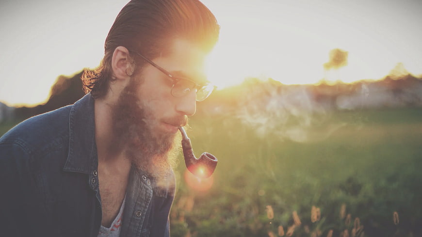 Bearded Man Smoking Pipe in Golden Hour Sunlight