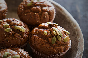 Homemade Pumpkin Muffins with Seeds on Rustic Plate