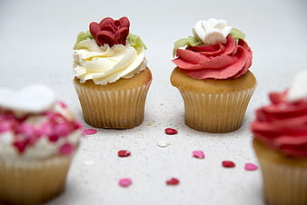Decorated Cupcakes with Heart Sprinkles on White Background