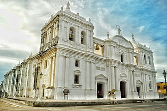 White Baroque Church Facade with Bell Tower and Statues