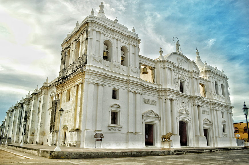 White Baroque Church Facade with Bell Tower and Statues