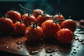 Fresh Red Tomatoes with Water Droplets on Dark Wood