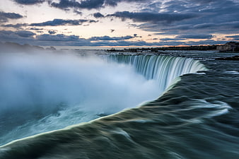 Majestic Niagara Falls Waterfall at Sunset with Mist