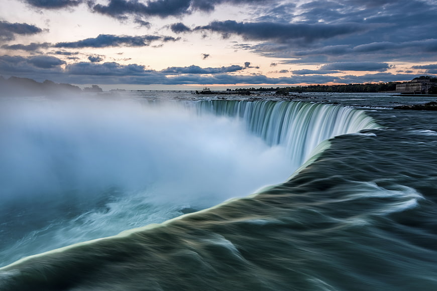 Majestic Niagara Falls Waterfall at Sunset with Mist