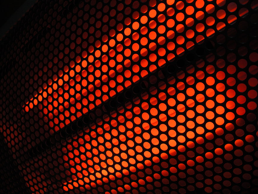 Abstract Glowing Red Perforated Metal Grid Pattern