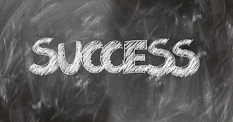 Success written in chalk on a blackboard background
