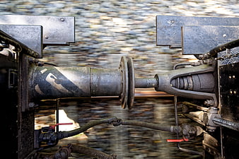 Close-up of train coupling mechanism in motion on tracks