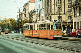 Vintage Orange Tram 49 on City Street with Architecture