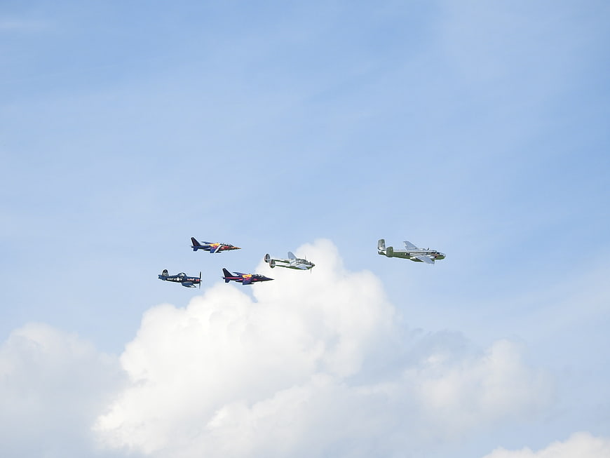 Vintage and Modern Aircraft Flying in Formation
