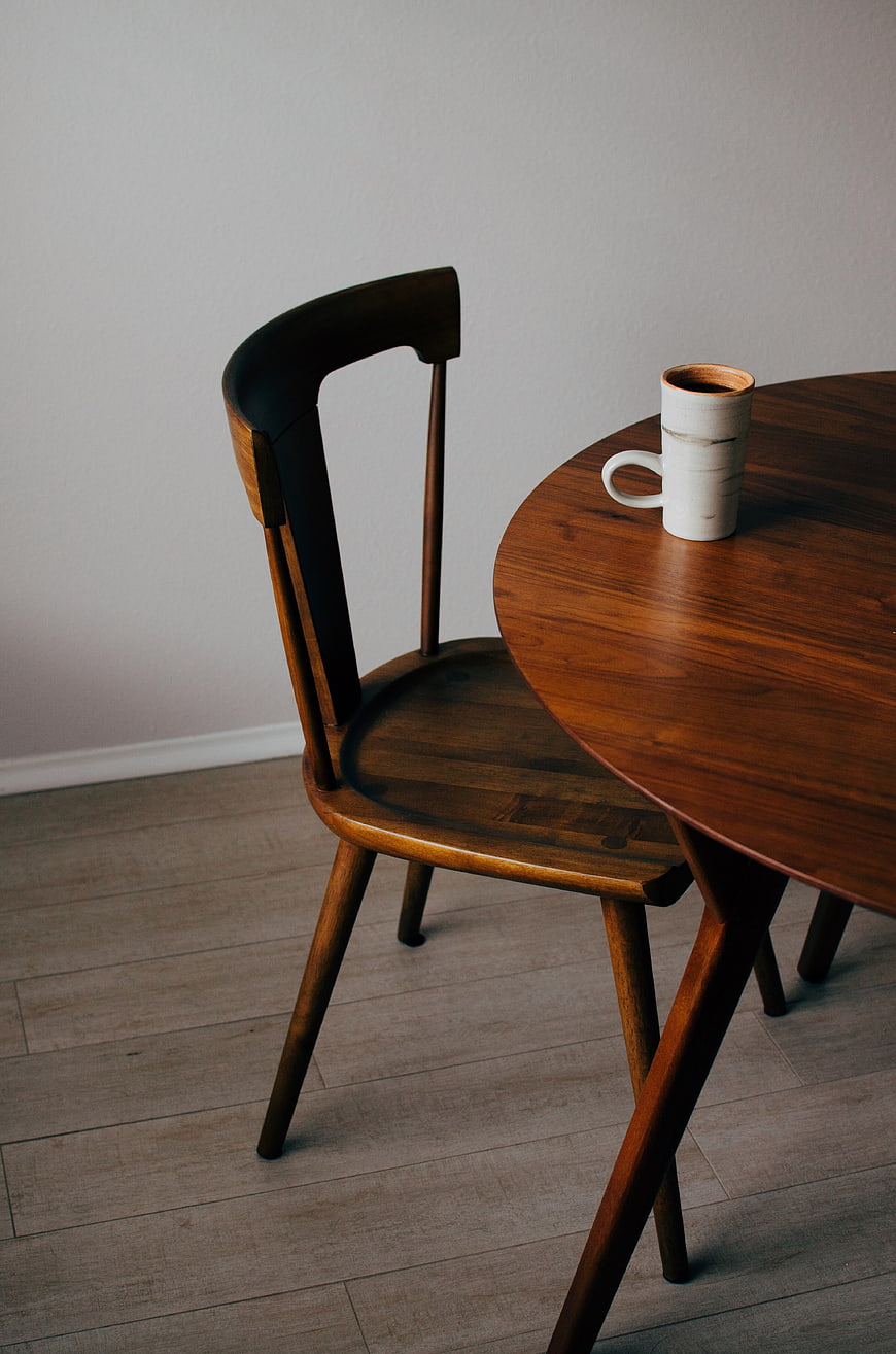 Minimalist wooden chair and table with ceramic coffee mug