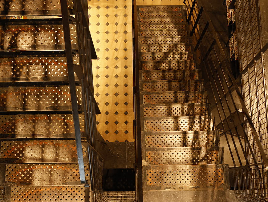 Industrial metal stairs with diamond pattern and warm lighting