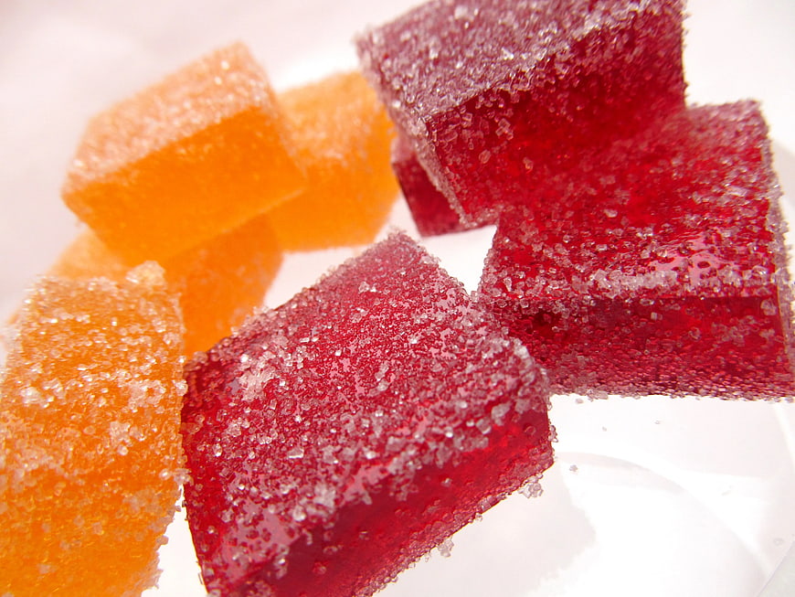 Close-up of red and orange sugar-coated vitamin gummy candies