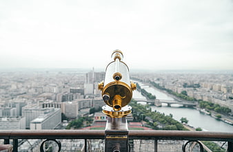 Gold Telescope on Eiffel Tower Overlooking Paris Cityscape