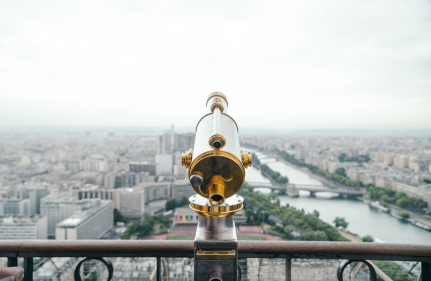 Gold Telescope on Eiffel Tower Overlooking Paris Cityscape