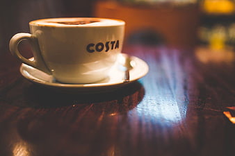 Costa Coffee Cup on Wooden Table