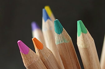Close-up of colorful wooden pencil tips on dark background