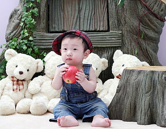 Cute Asian Baby Boy Holding Red Apple With Teddy Bears