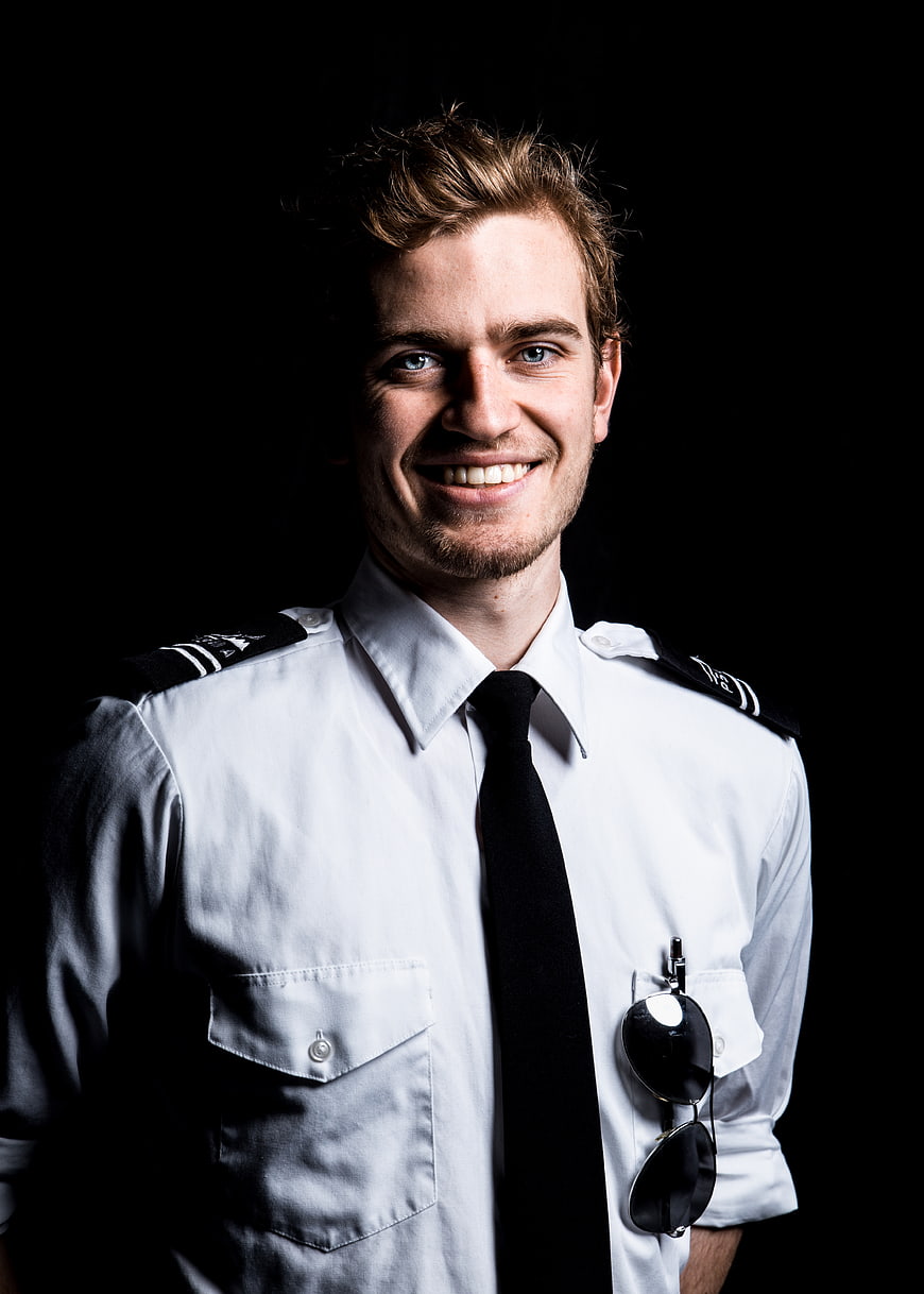 Portrait of smiling male pilot in uniform