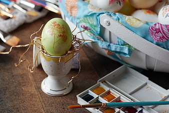 Hand-painted Easter egg with watercolors and brush