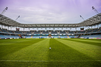 Empty Soccer Stadium with Ball on Green Grass Field