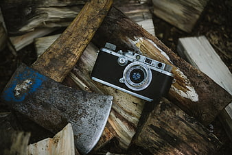 Vintage Leica Camera and Axe on Chopped Wood