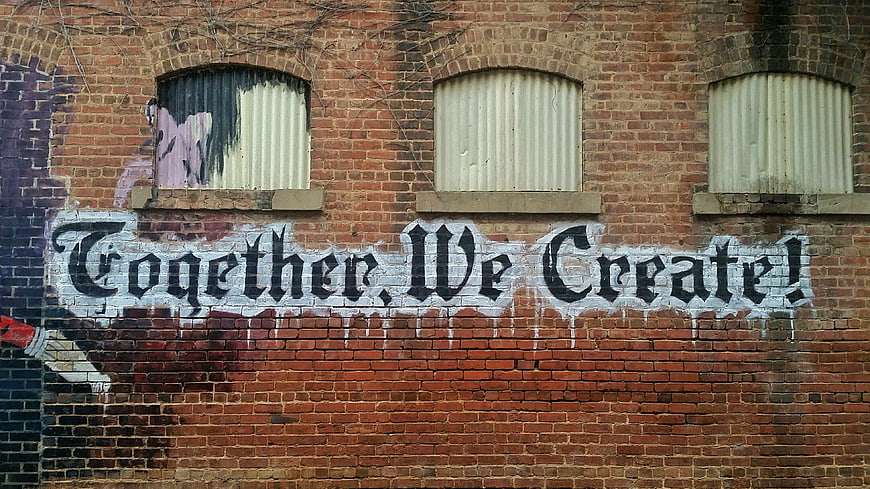 Together We Create Graffiti on Brick Wall