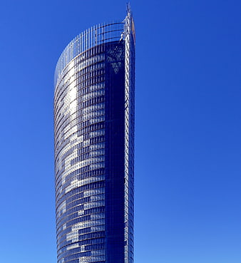 Modern glass skyscraper against clear blue sky