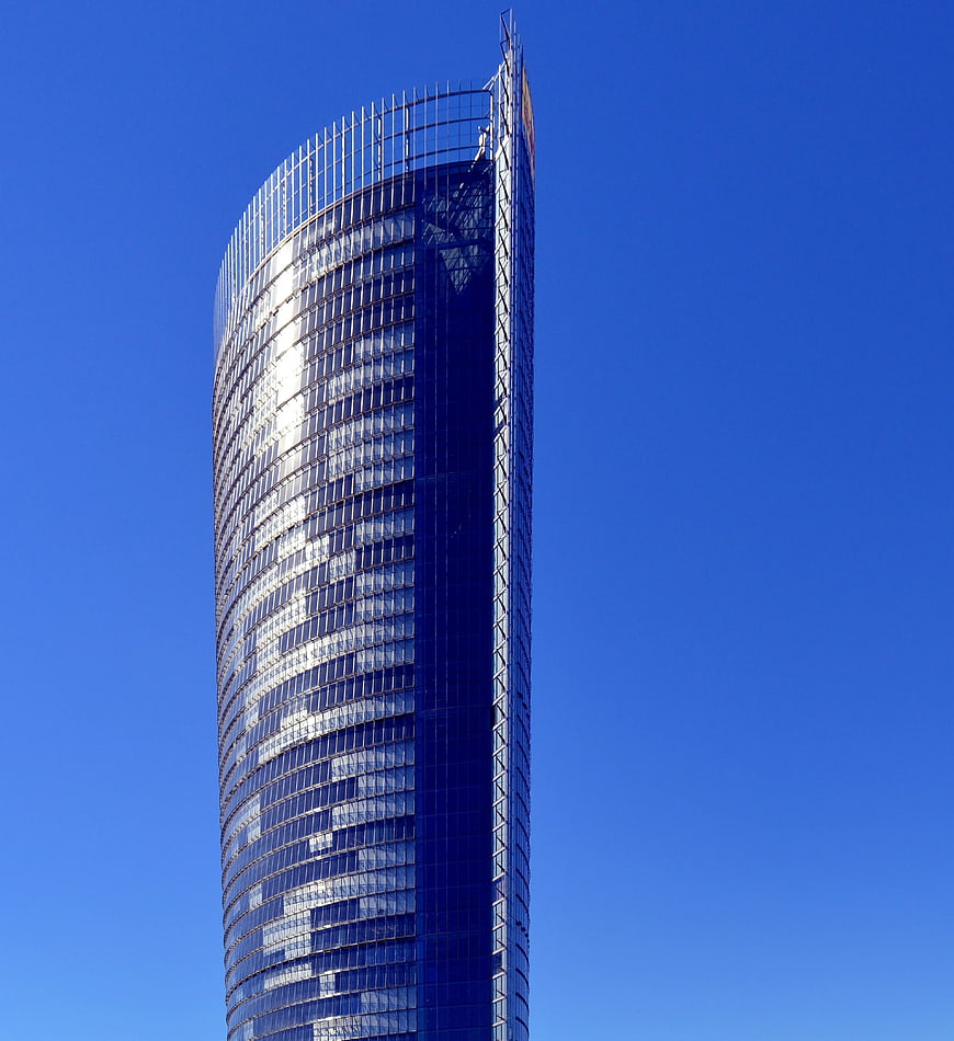 Modern glass skyscraper against clear blue sky