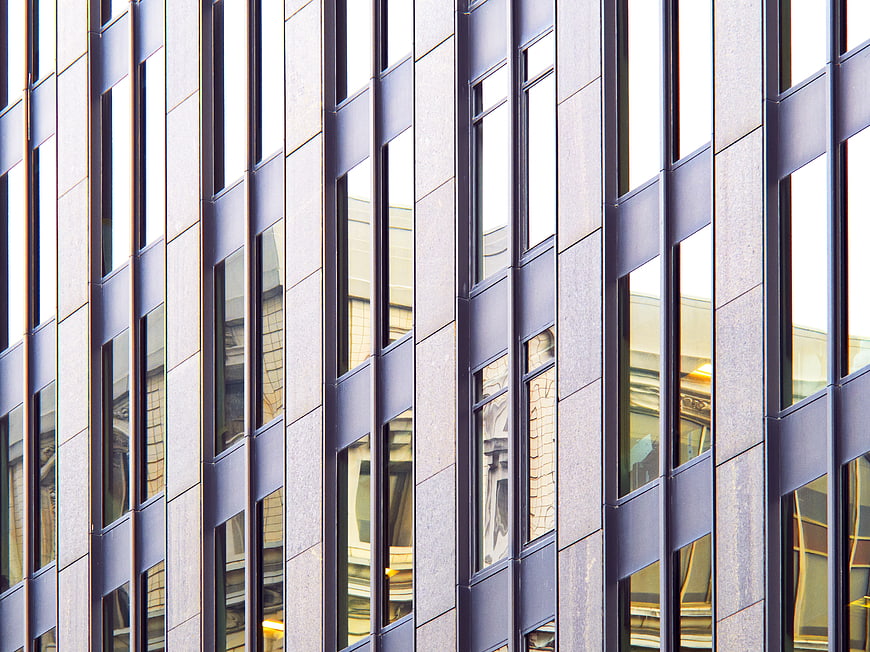 Modern Building Facade with Vertical Windows and Reflections