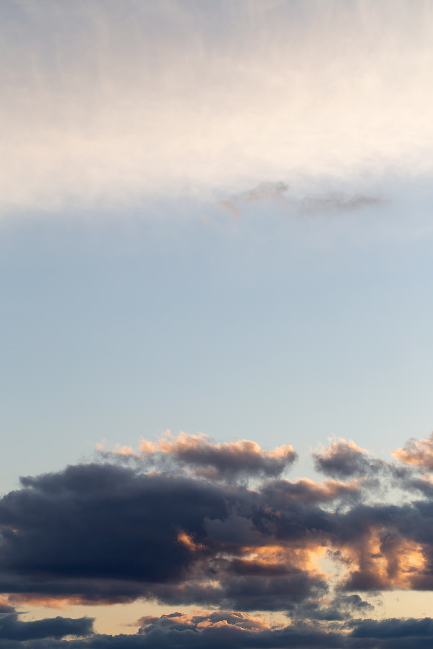 Dramatic sunset clouds with golden light against blue sky