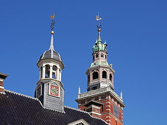 Historic clock towers against a clear blue sky