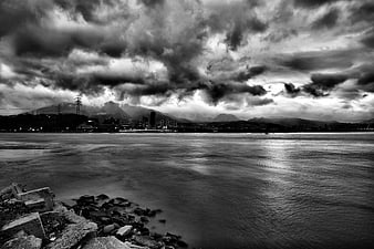 Dramatic Black and White Coastal Cityscape with Stormy Sky