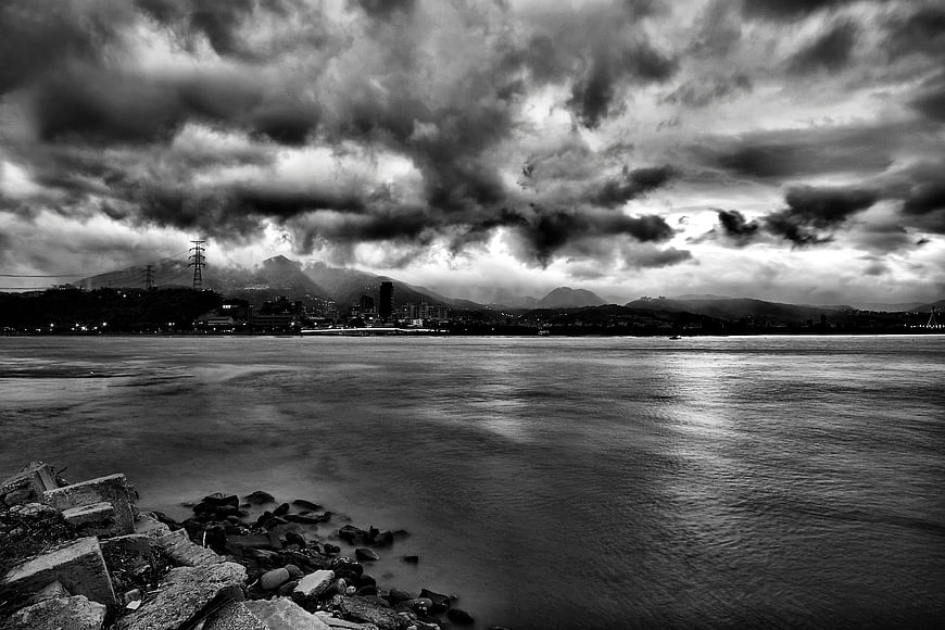 Dramatic Black and White Coastal Cityscape with Stormy Sky