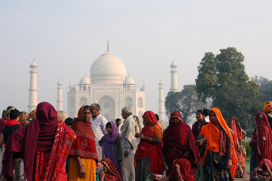 Tourists in traditional clothing visiting the Taj Mahal