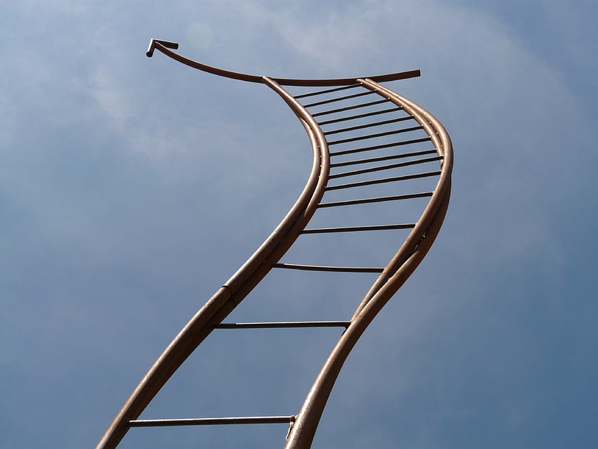 Metal Ladder Sculpture Reaching Toward Blue Sky