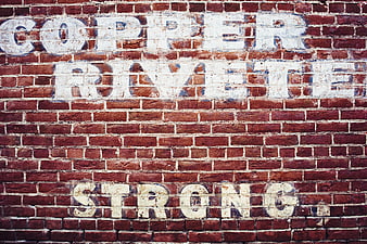 Vintage Ghost Sign on Red Brick Wall