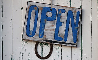 Rustic Wooden Open Sign on Weathered White Door