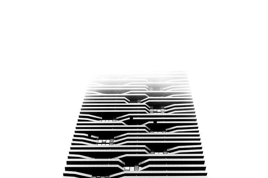 Black and white skyscraper fading into white fog