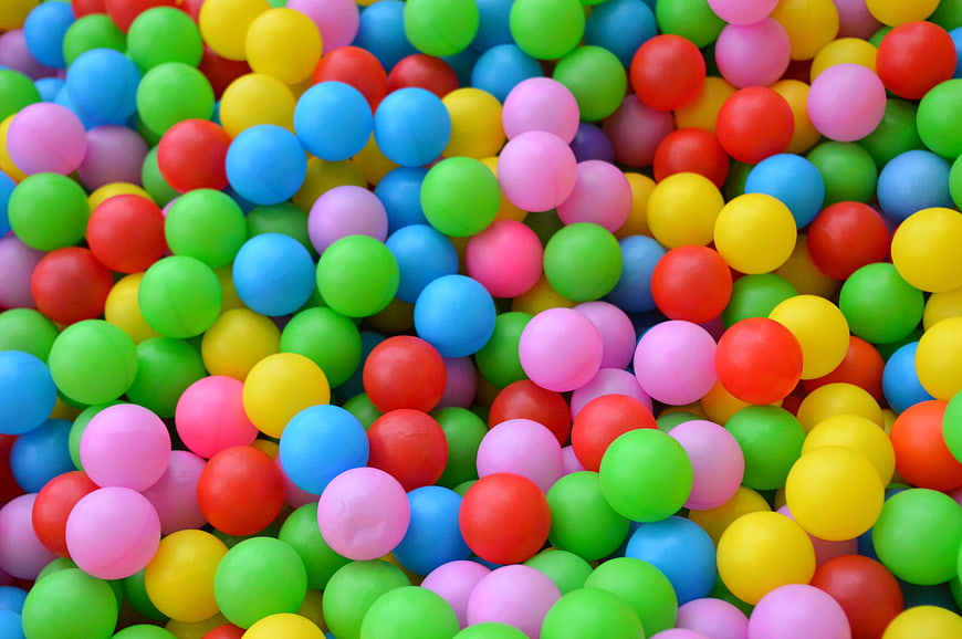 Close-up of colorful plastic balls in a children's ball pit