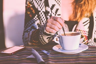 Woman Stirring Coffee in Patterned Sweater