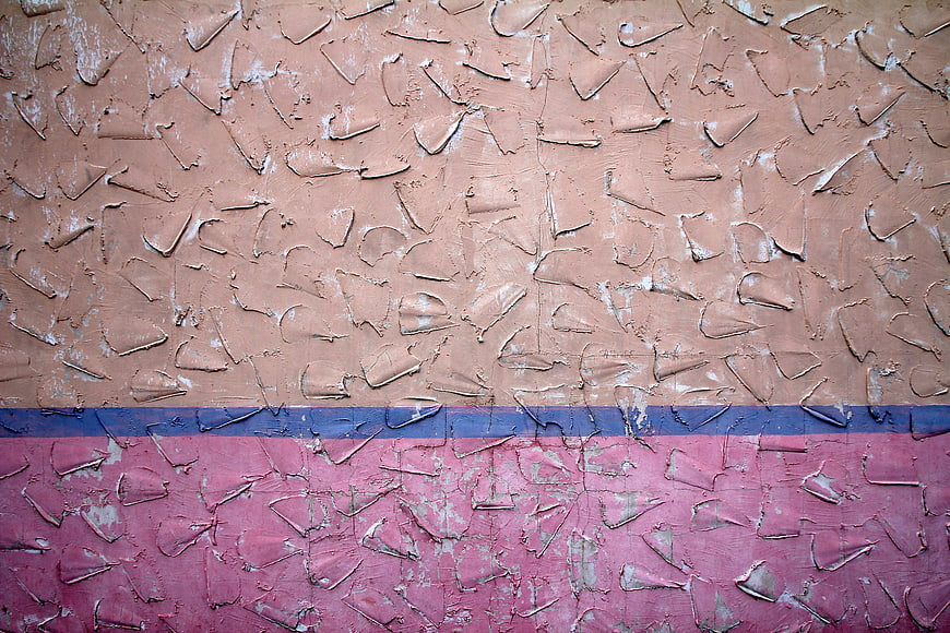 Textured Wall with Peeling Paint in Pink, Blue, and Beige