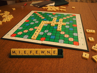 Scrabble board game with tiles on wooden table