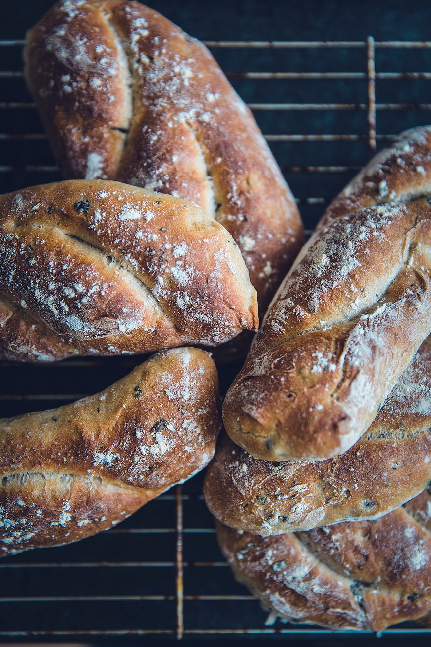 Freshly baked rustic bread loaves on cooling rack