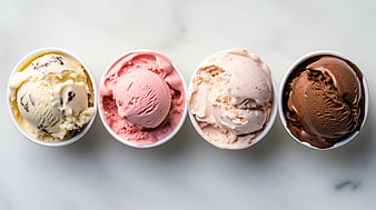 Top View of Four Ice Cream Bowls on White Marble