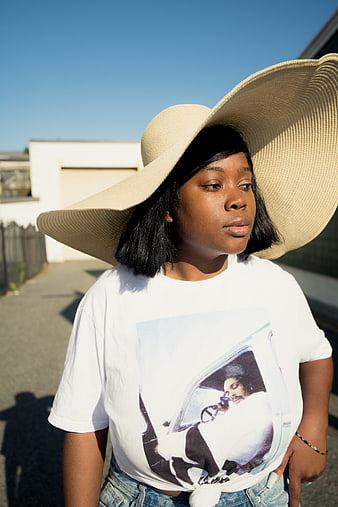 Stylish Black Woman in Oversized Straw Hat and Graphic Tee