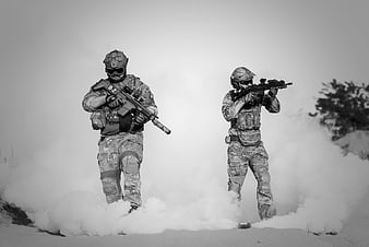 Two soldiers in tactical gear advancing through smoke