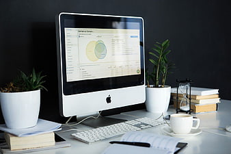 Minimalist Workspace with Mac Computer and Analytics Dashboard