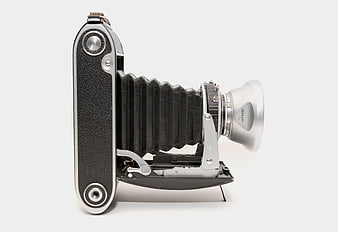 Vintage folding camera on white background